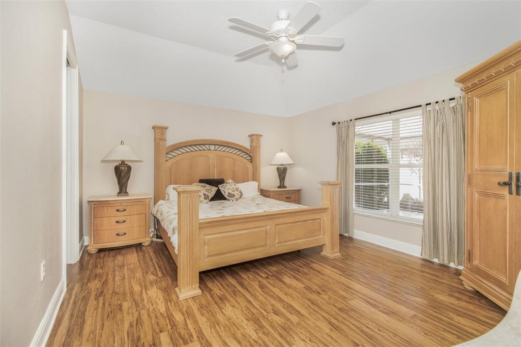 19331 Haskell Place Land O Lakes, FL 34638 - Photo 18 of 34 a view of a bedroom with furniture window and wooden floor