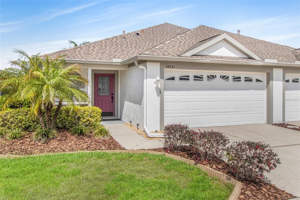 19331 Haskell Place Land O Lakes, FL 34638 - Photo 2 of 34 a front view of a house with garden