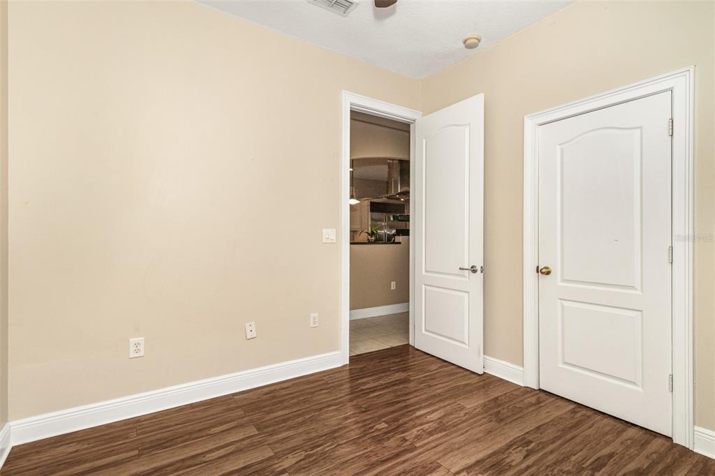 19331 Haskell Place Land O Lakes, FL 34638 - Photo 23 of 34 an empty room with wooden floor & closet and windows
