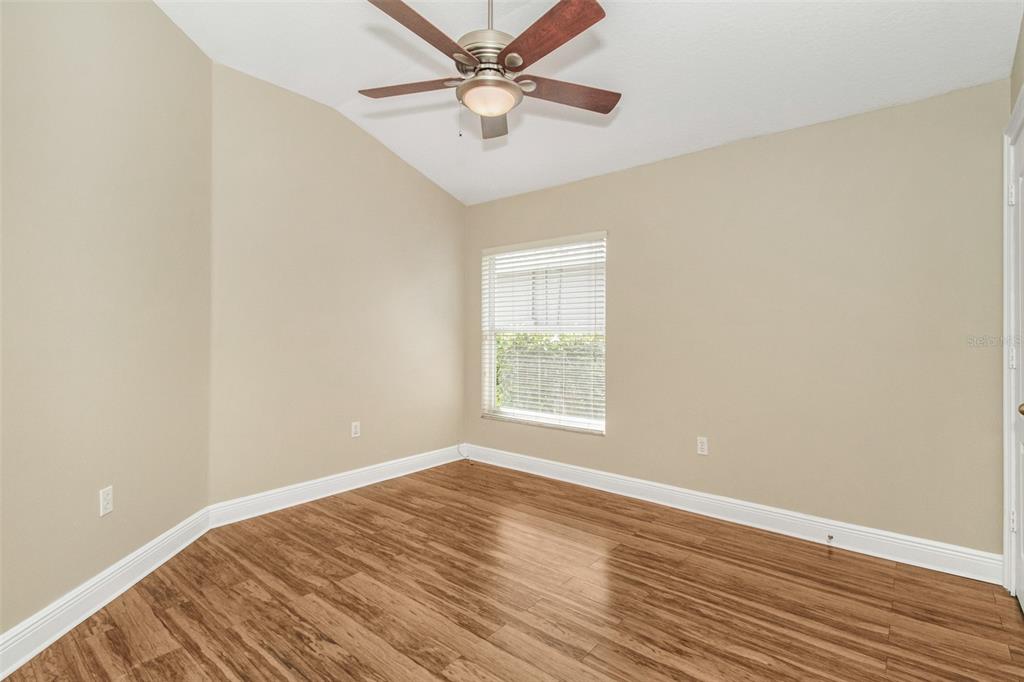 19331 Haskell Place Land O Lakes, FL 34638 - Photo 24 of 34 an empty room with wooden floor and windows