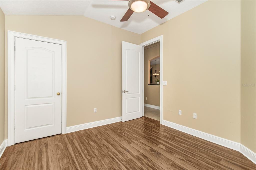 19331 Haskell Place Land O Lakes, FL 34638 - Photo 25 of 34 an empty room with wooden floor and windows