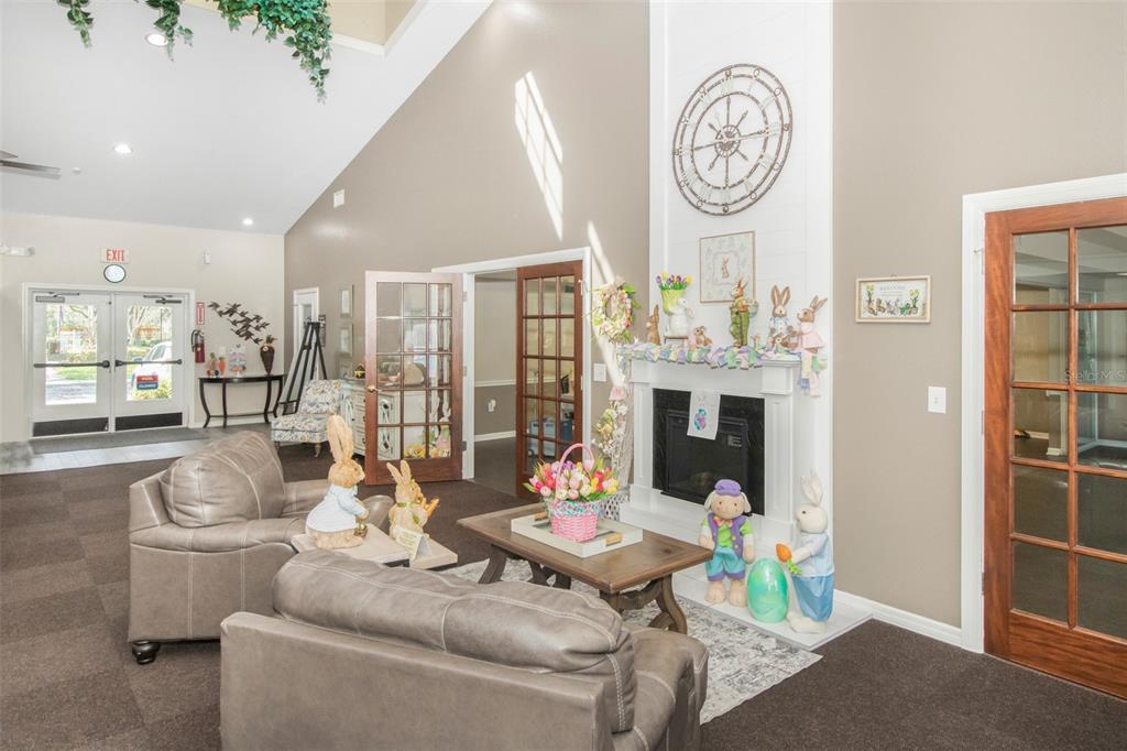19331 Haskell Place Land O Lakes, FL 34638 - Photo 32 of 34 a living room with furniture a clock and a fireplace
