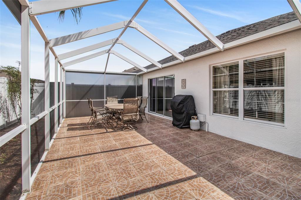 19331 Haskell Place Land O Lakes, FL 34638 - Photo 4 of 34 a view of a patio with table and chairs and a barbeque