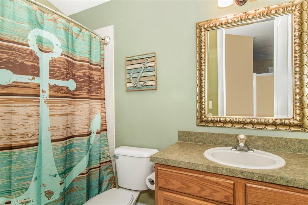 19331 Haskell Place Land O Lakes, FL 34638 - Photo 6 of 34 a bathroom with a granite countertop toilet sink and mirror