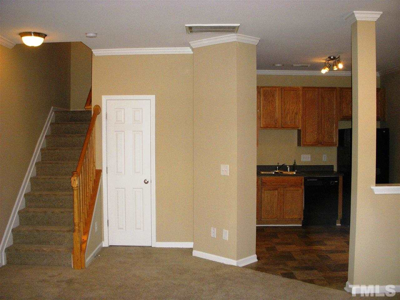 11720 Coppergate Drive, Unit 111 Raleigh, NC 27614 - Photo 2 of 15 a view of a kitchen with refrigerator and cabinets