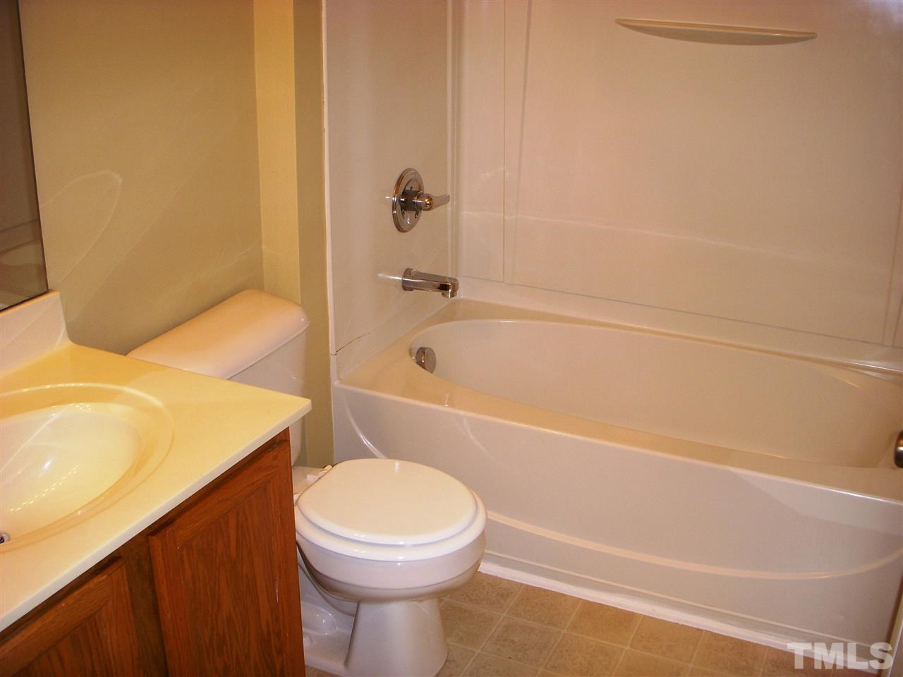 11720 Coppergate Drive, Unit 111 Raleigh, NC 27614 - Photo 13 of 15 a bathroom with a sink a toilet and bathtub