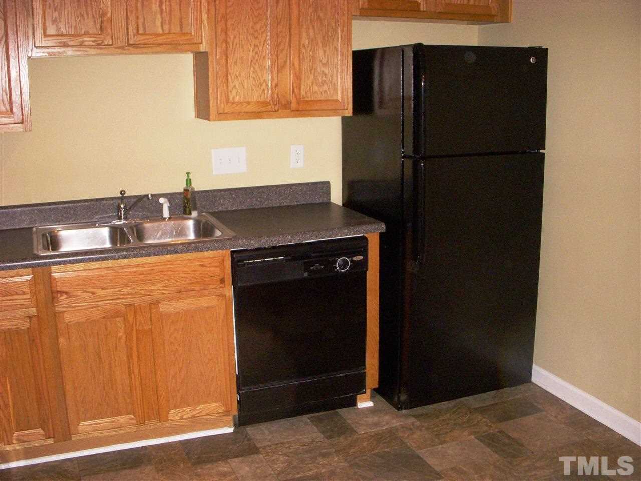 11720 Coppergate Drive, Unit 111 Raleigh, NC 27614 - Photo 4 of 15 a kitchen with a refrigerator and a sink