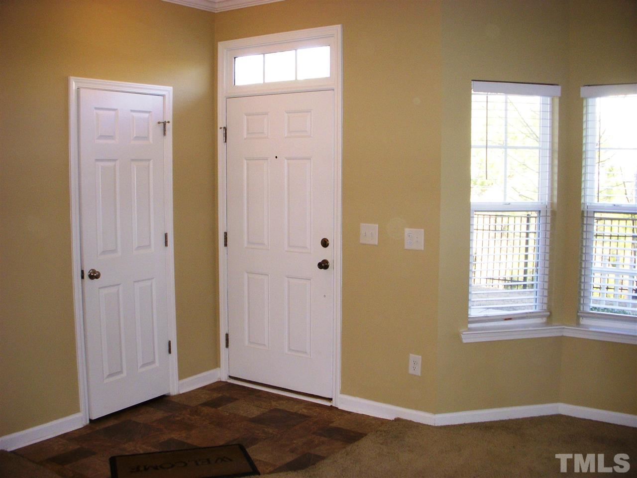 11720 Coppergate Drive, Unit 111 Raleigh, NC 27614 - Photo 6 of 15 a view of an empty room with wooden floor and a window