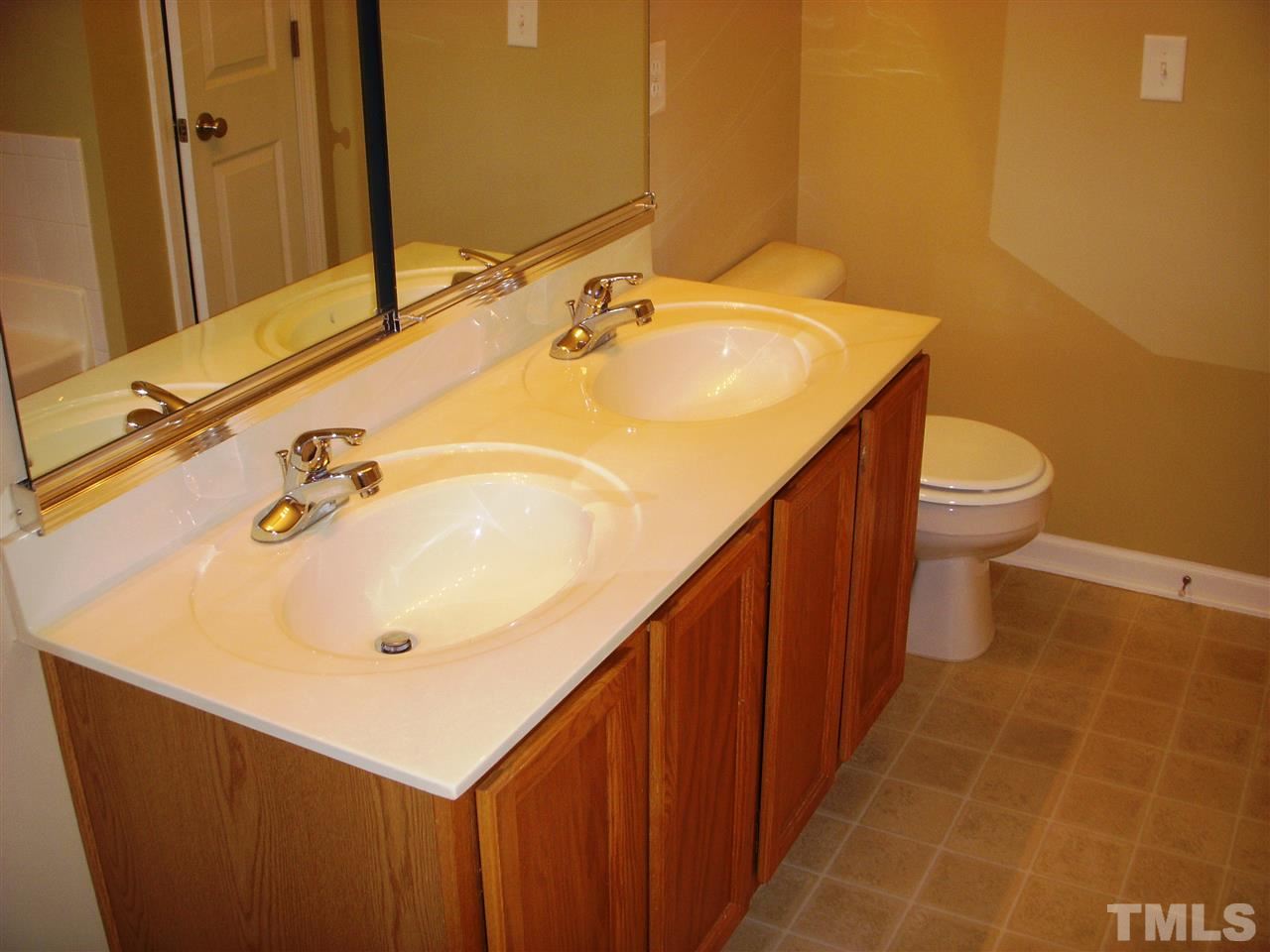 11720 Coppergate Drive, Unit 111 Raleigh, NC 27614 - Photo 9 of 15 a bathroom with a sink and mirror