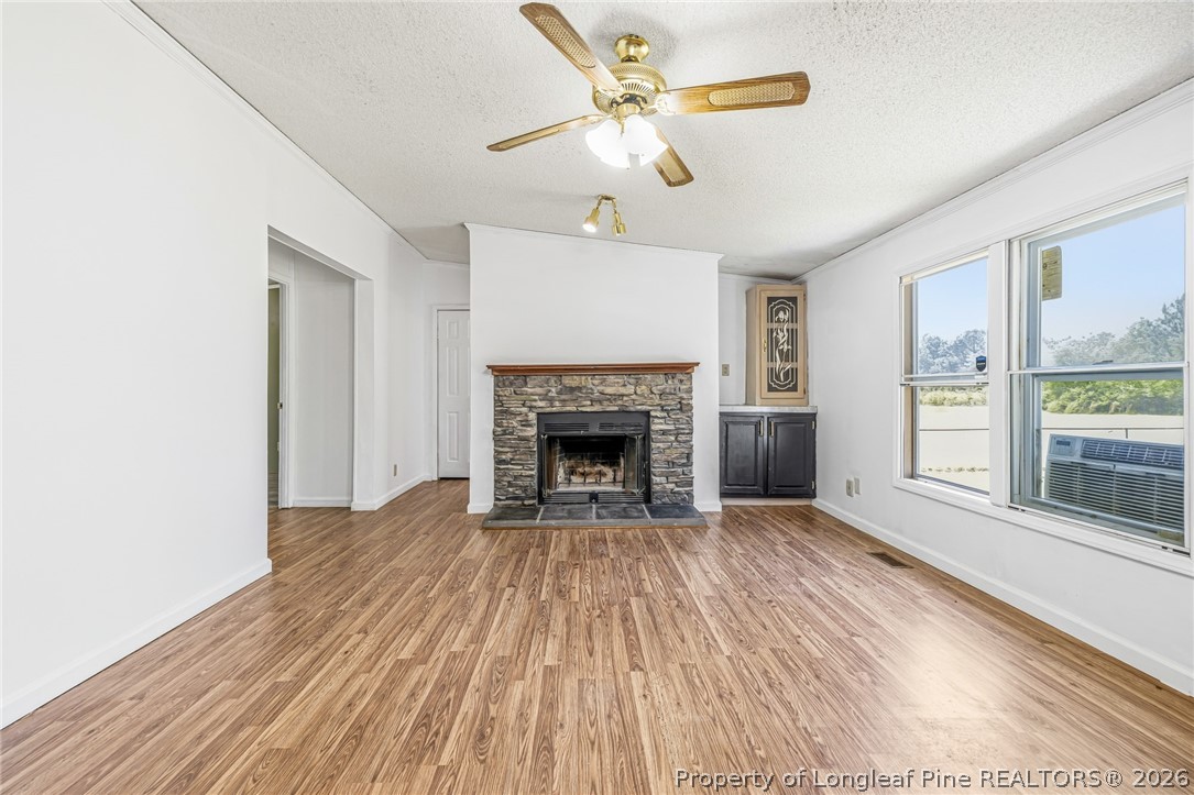 105 Valley Forge Way North Cameron, NC 28326 - Photo 12 of 33 a view of a livingroom with a fireplace a ceiling fan and wooden floor
