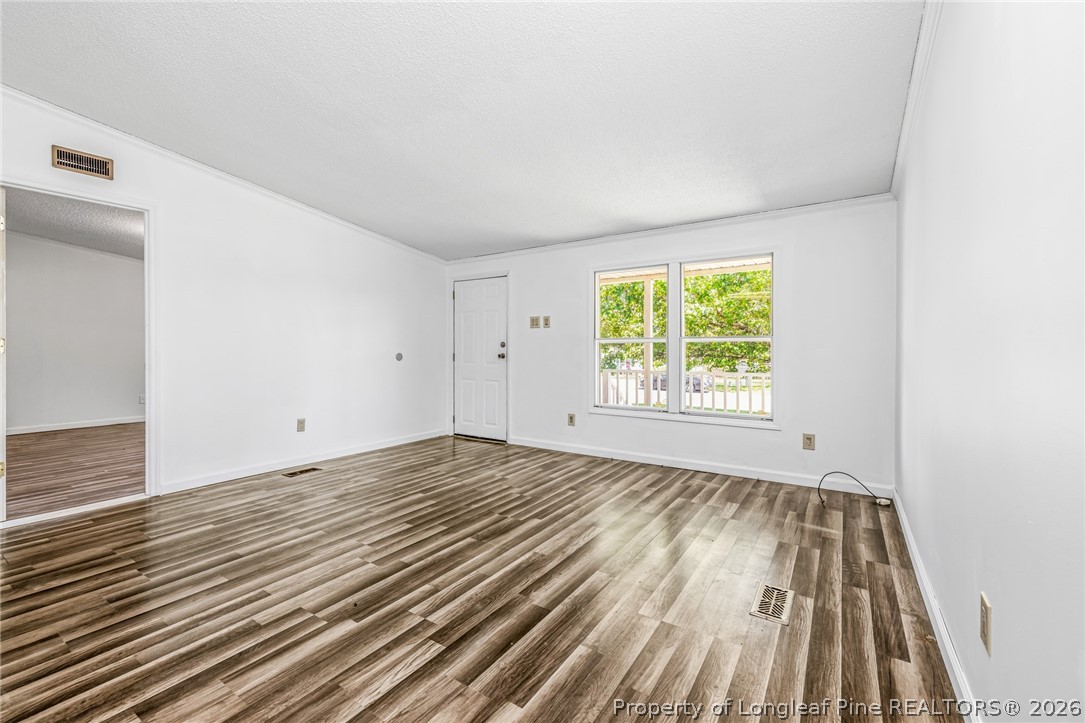 105 Valley Forge Way North Cameron, NC 28326 - Photo 18 of 33 an empty room with wooden floor and windows