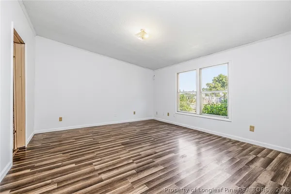 a view of room with window and hardwood floor