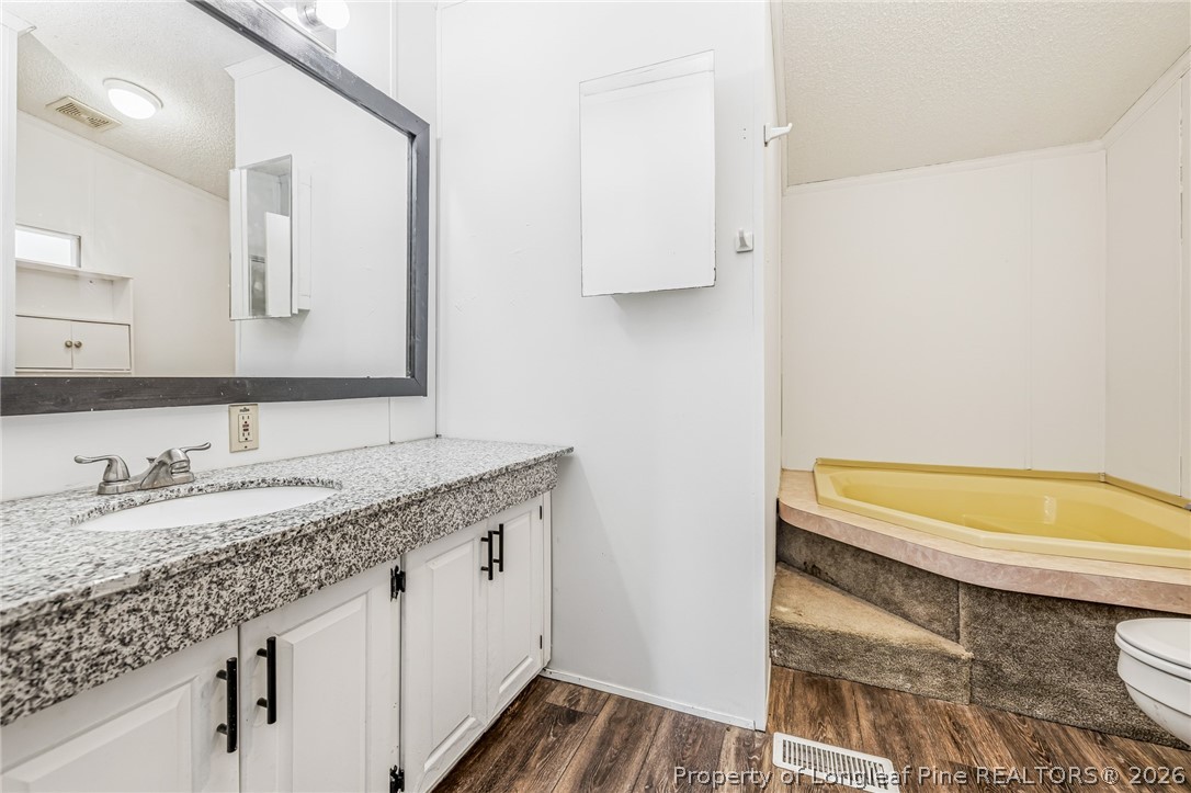 105 Valley Forge Way North Cameron, NC 28326 - Photo 26 of 33 a bathroom with a granite countertop sink and a mirror