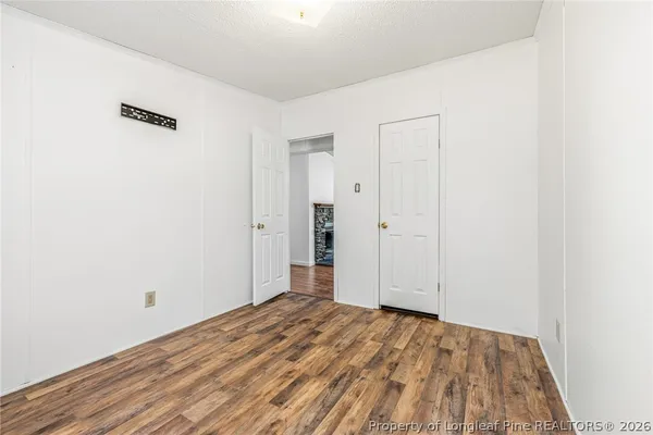 a view of a room with wooden floor and closet