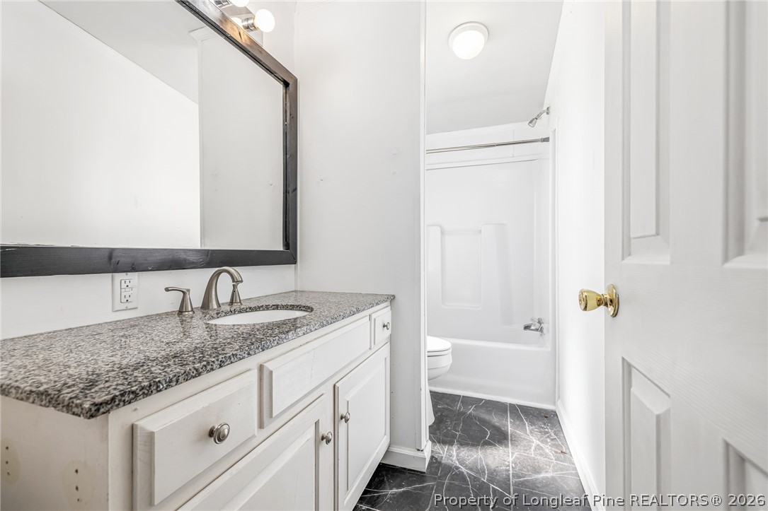 105 Valley Forge Way North Cameron, NC 28326 - Photo 33 of 33 a bathroom with a granite countertop sink and a mirror