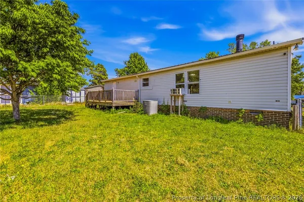 a view of a house with a backyard