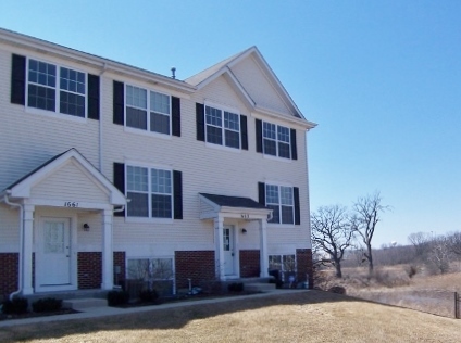 1663 West Turtle Creek Lane Round Lake, IL 60073 - Photo 1 of 25 a front view of a house with a yard