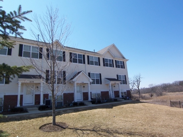1663 West Turtle Creek Lane Round Lake, IL 60073 - Photo 2 of 25 a front view of a house with a yard