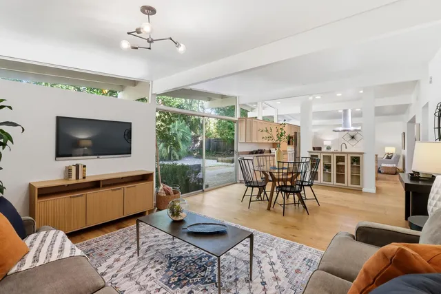 a dining room with kitchen island a chandelier and a stove