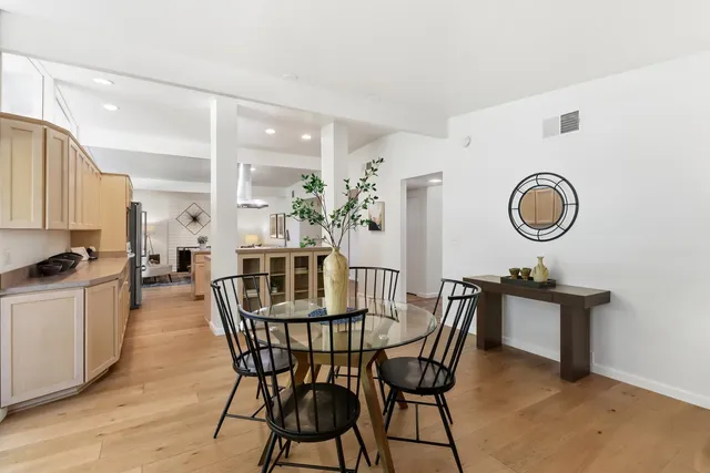 a kitchen with kitchen island granite countertop a sink and cabinets