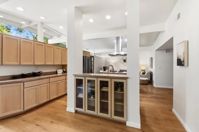 a kitchen with sink stove and refrigerator