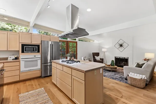 a living room with furniture a fireplace and a window