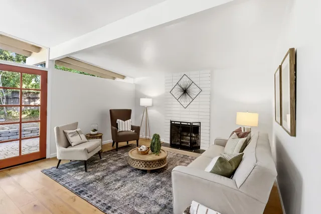 a living room with furniture a dining table and a chandelier