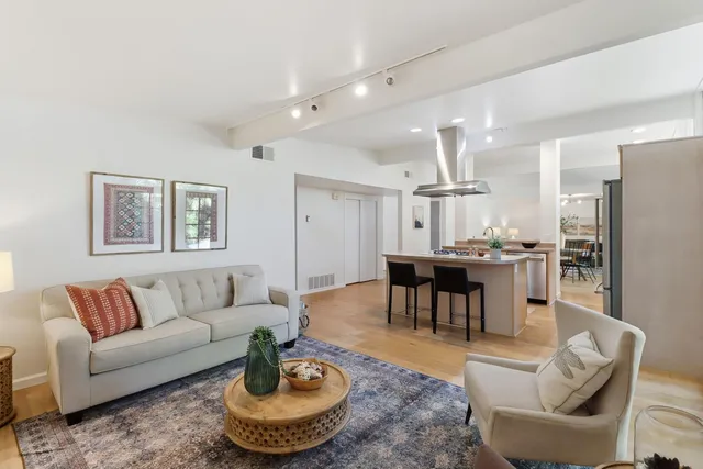 a kitchen with stainless steel appliances kitchen island granite countertop a refrigerator and a stove top oven