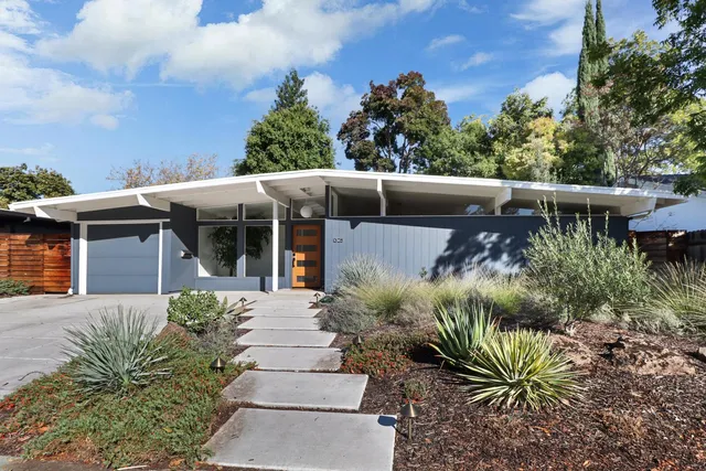 a front view of a house with garden