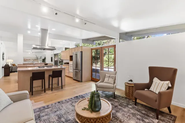 a kitchen with stainless steel appliances kitchen island granite countertop a stove and a sink