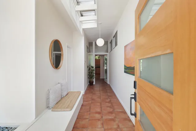 a living room with furniture a window and a potted plant