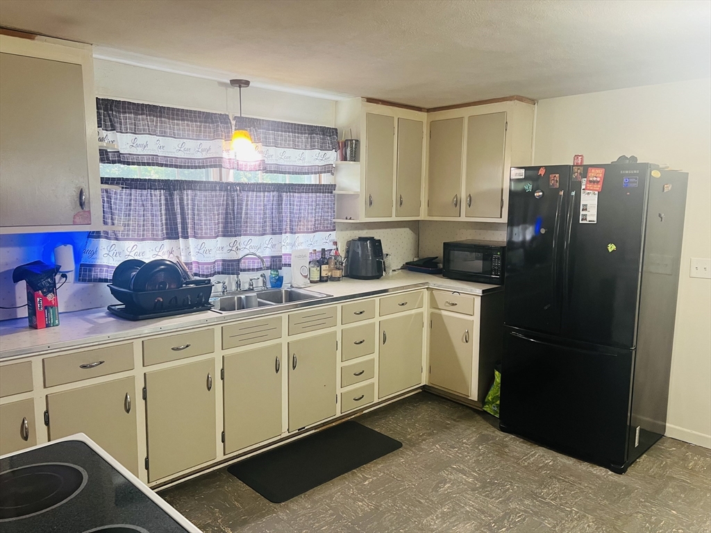 64 Fox Hill Road Springfield, MA 01118 - Photo 4 of 14 a kitchen with cabinets and appliances