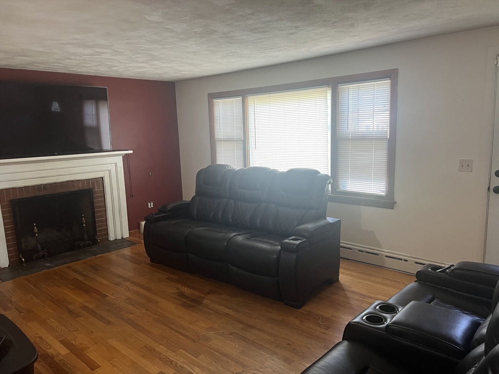 64 Fox Hill Road Springfield, MA 01118 - Photo 6 of 14 a living room with furniture and a fireplace