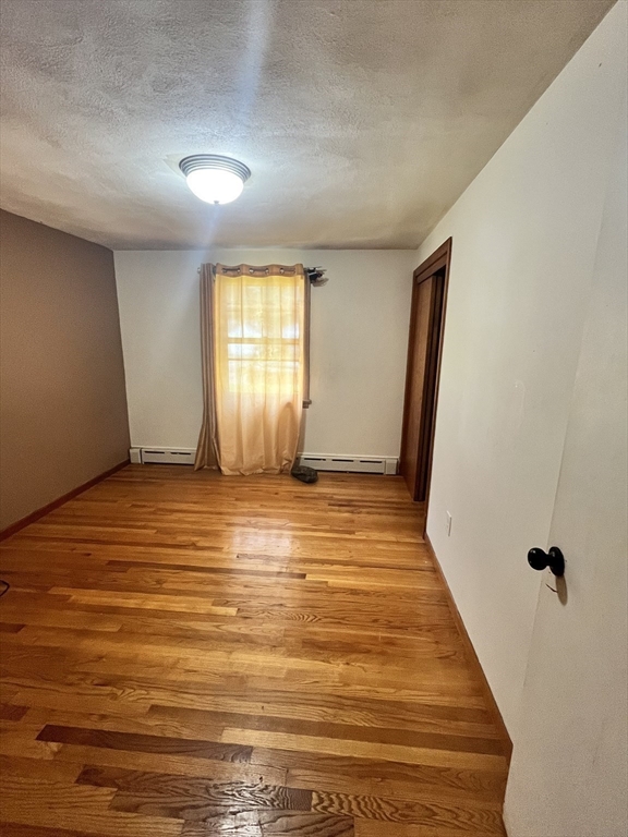 64 Fox Hill Road Springfield, MA 01118 - Photo 8 of 14 a view of an empty room with wooden floor and a window