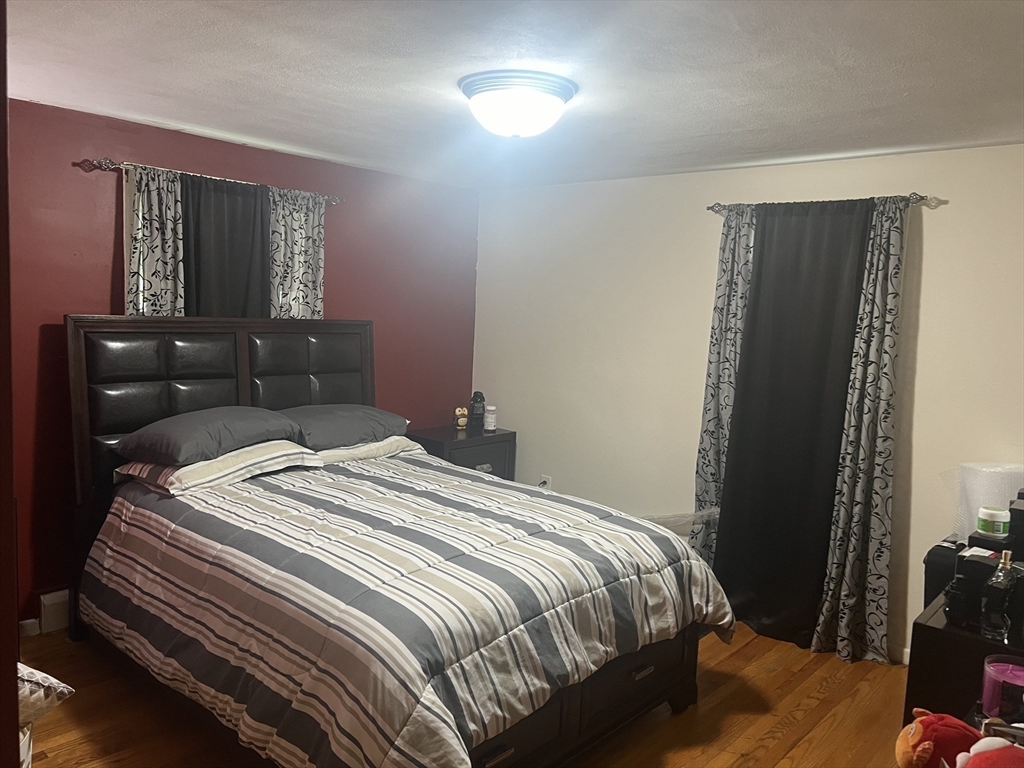 64 Fox Hill Road Springfield, MA 01118 - Photo 9 of 14 a bedroom with a bed and a mirror