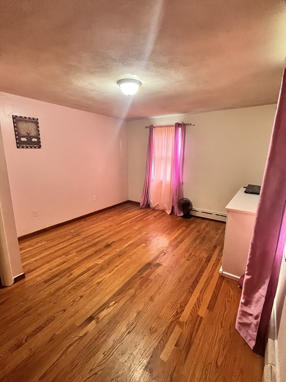 64 Fox Hill Road Springfield, MA 01118 - Photo 10 of 14 an empty room with wooden floor and windows