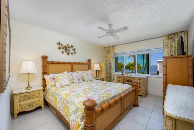 a bathroom with a sink a toilet a mirror and shower curtain