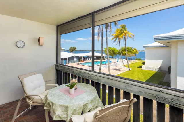 a view of a dining room with furniture a chandelier and wooden floor
