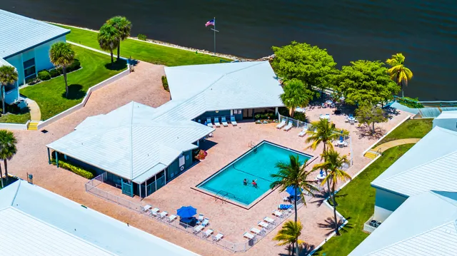 an aerial view of a house with swimming pool and porch