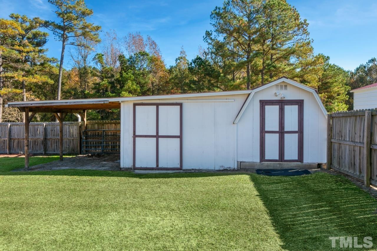 509 Surles Road Benson, NC 27504 - Photo 3 of 30 a view of a backyard with plants and large trees