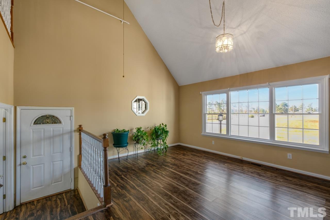 509 Surles Road Benson, NC 27504 - Photo 22 of 30 a view of an empty room with wooden floor and a window