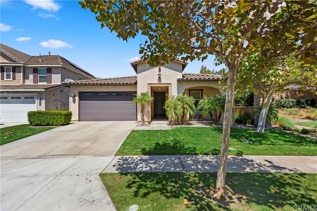 16000 Rimini Lane Fontana, CA 92336 - Photo 1 of 1 a front view of a house with a garden