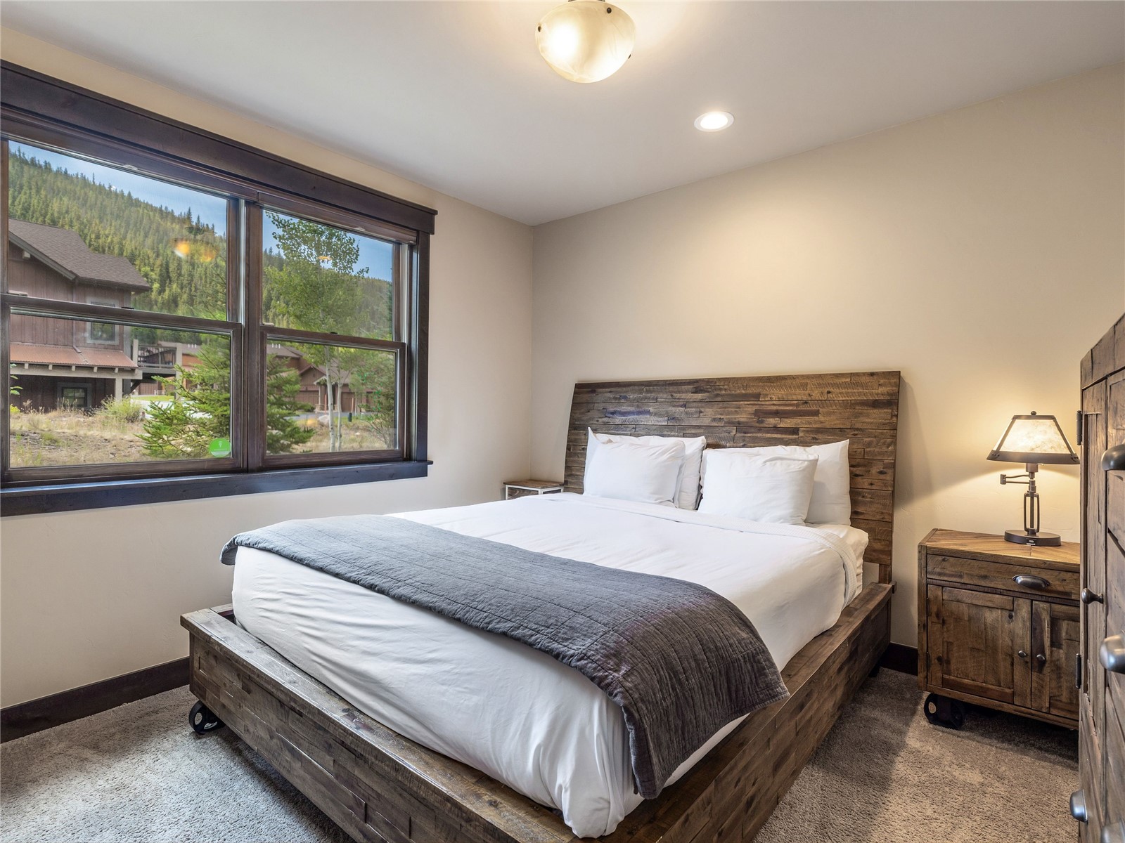 68 Independence Lane Keystone, CO 80435 - Photo 27 of 43 a bedroom with a bed lamp and window