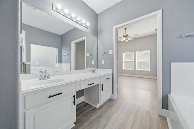 a spacious bathroom with a double vanity sink and a mirror