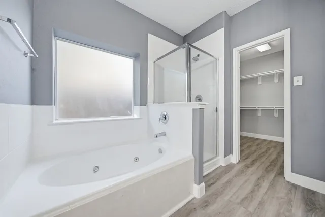 a bathroom with a bathtub and a shower