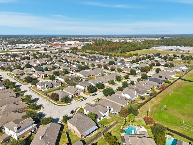 an aerial view of residential building and lake