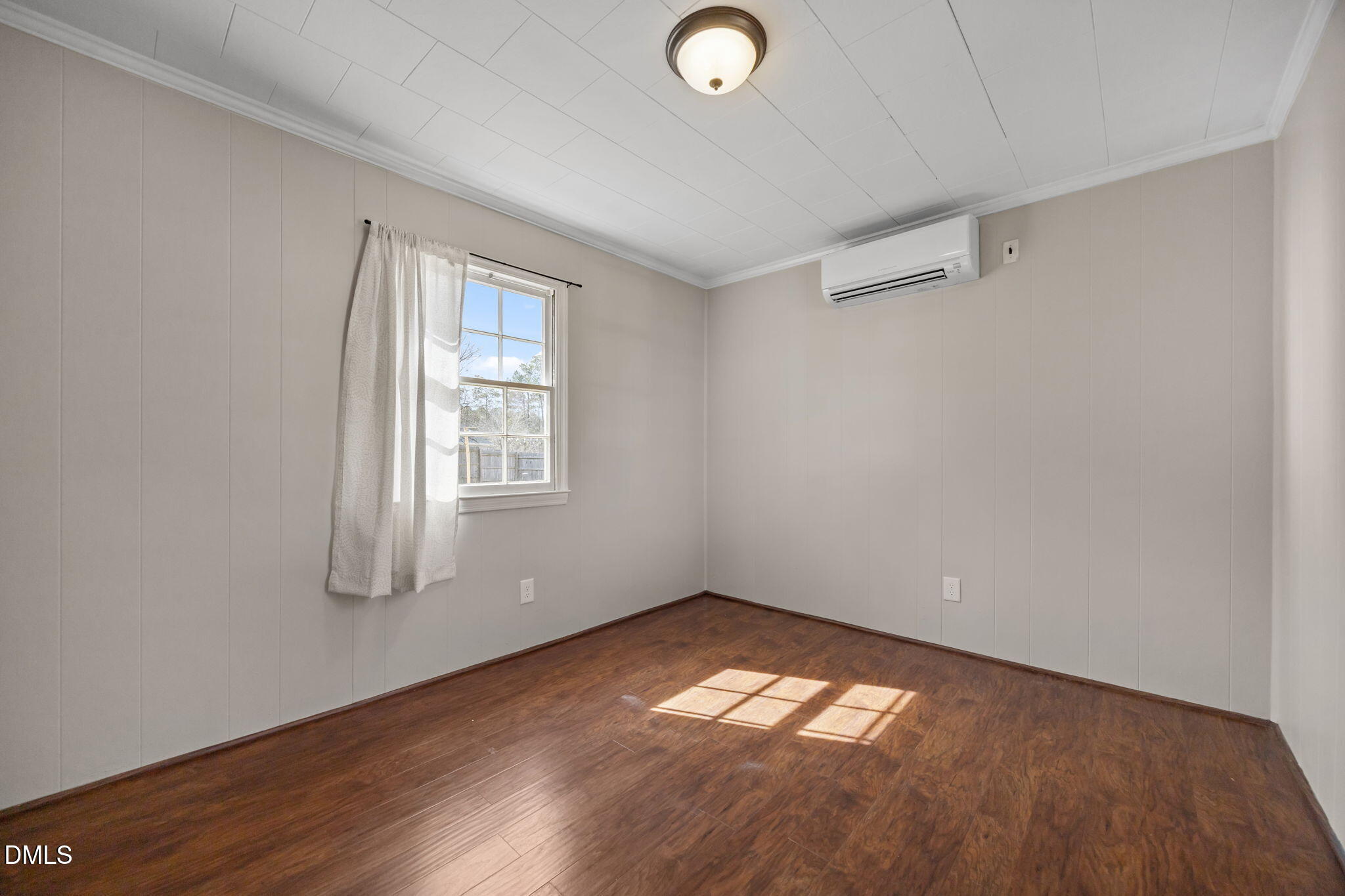209 Weston Road Garner, NC 27529 - Photo 16 of 37 an empty room with wooden floor and windows