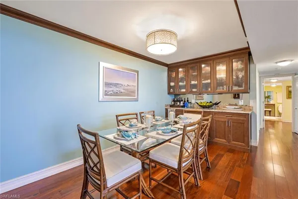 a dining room with furniture and wooden floor