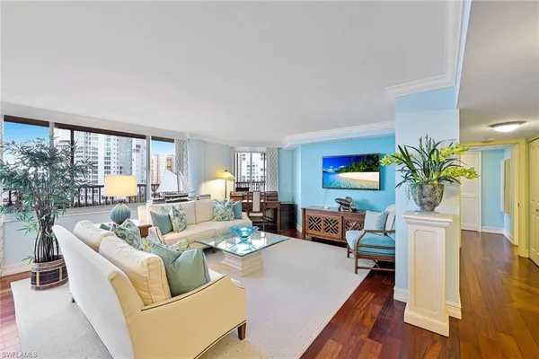 a living room with fireplace furniture and a potted plant