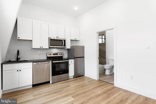 a kitchen with a sink and a stove top oven